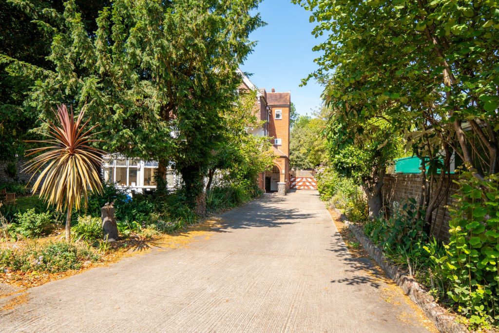 Driveway entrance lined with trees